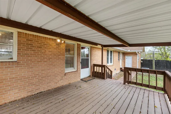 a view of a patio with table and chairs and wooden floor