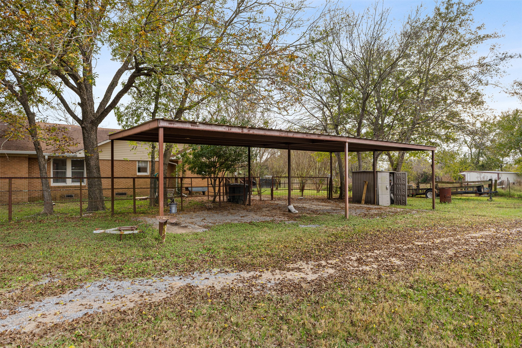 195 L County Road Jewett, TX 75846 - Photo 23 of 26 a view of a house with backyard and a tree