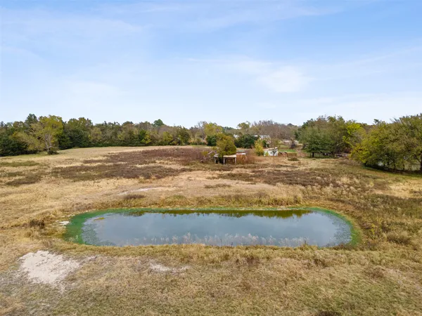 a view of a lake with trees and mountains in the background