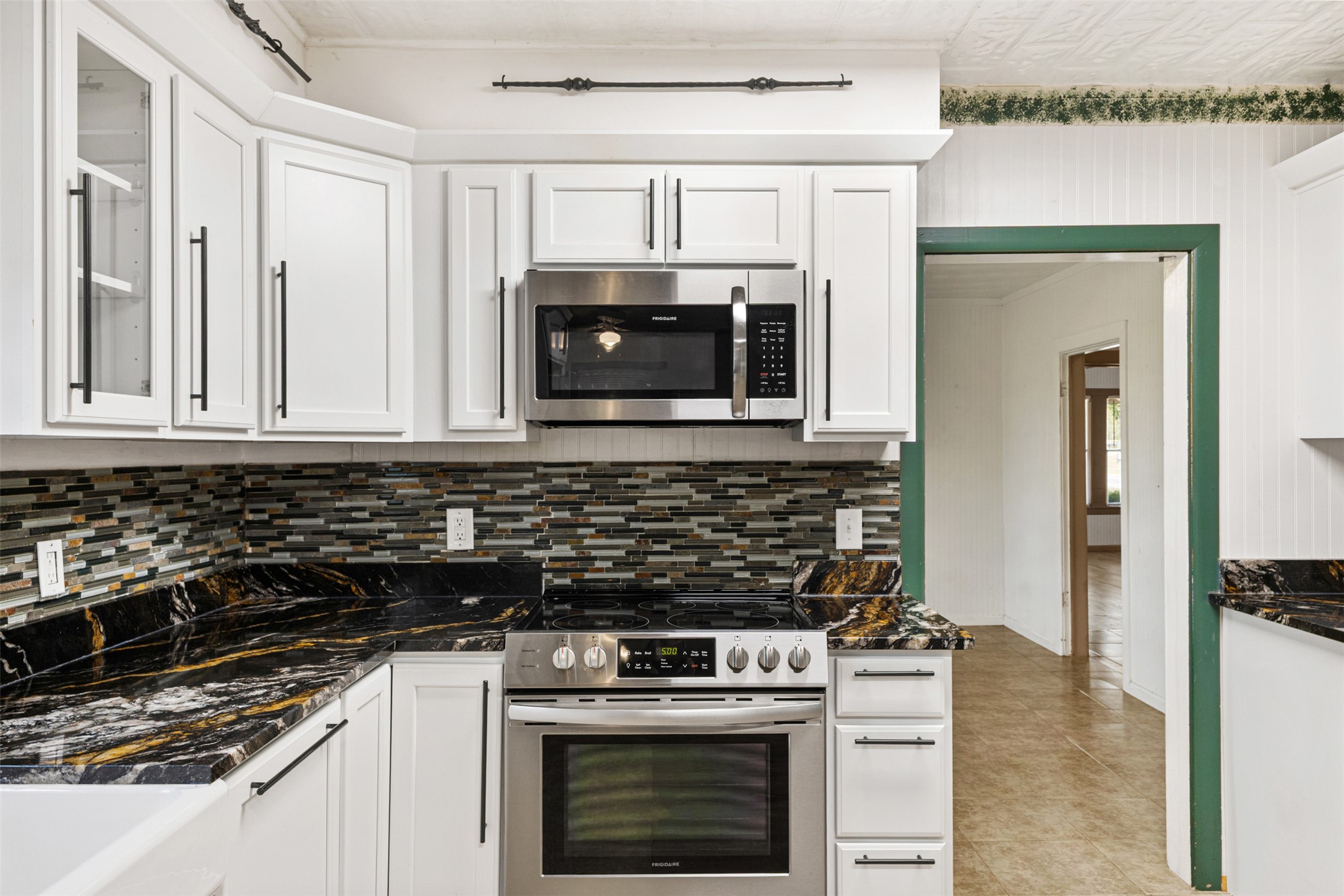 195 L County Road Jewett, TX 75846 - Photo 8 of 26 a kitchen with granite countertop white cabinets and stainless steel appliances