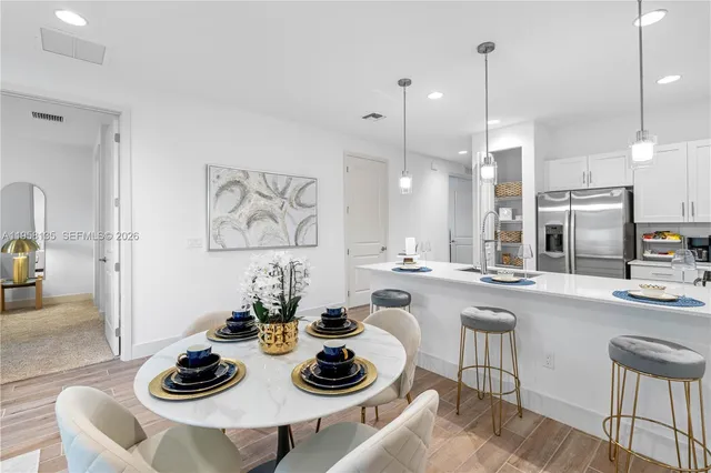 a kitchen with a table and chairs
