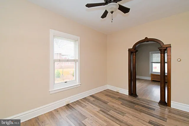 a view of space with wooden floor and window