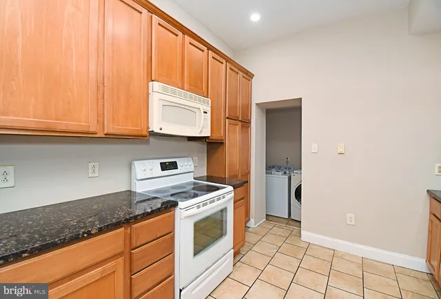 a kitchen with a sink and chandelier