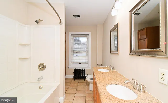 a bathroom with a tub and shower