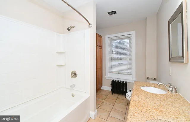 an empty room with closet and a chandelier fan