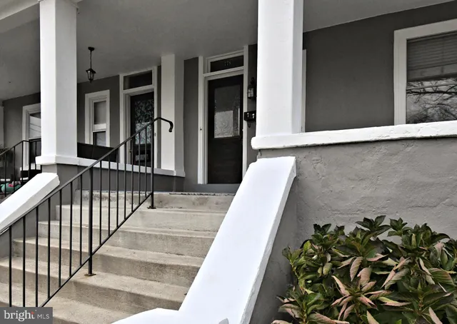 a view of a livingroom with couch wooden floor and a window