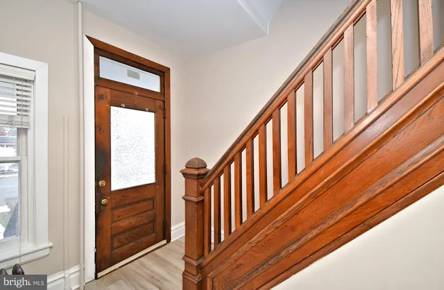 a view of a livingroom with wooden floor and a window