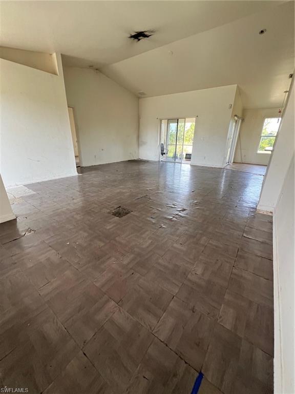 3513 30th Street Southwest Lehigh Acres, FL 33976 - Photo 14 of 29 an empty room with wooden floor and windows