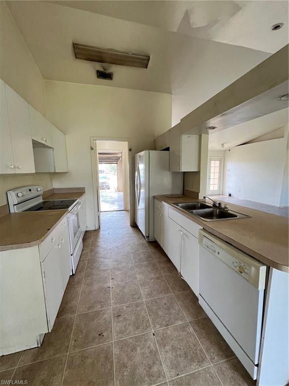 3513 30th Street Southwest Lehigh Acres, FL 33976 - Photo 16 of 29 a large kitchen with stainless steel appliances a stove a sink dishwasher and a refrigerator