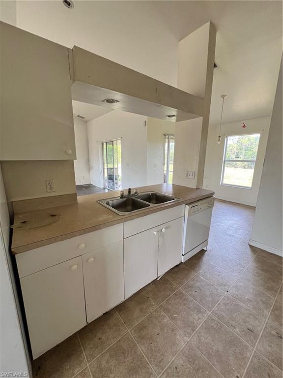3513 30th Street Southwest Lehigh Acres, FL 33976 - Photo 18 of 29 a large white kitchen with a large window