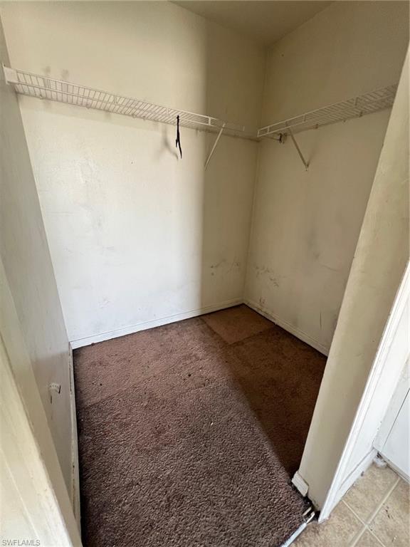 3513 30th Street Southwest Lehigh Acres, FL 33976 - Photo 24 of 29 a view of a room with racks on the wall