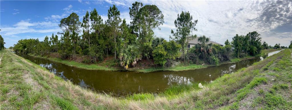 3513 30th Street Southwest Lehigh Acres, FL 33976 - Photo 29 of 29 a view of a lake with a yard