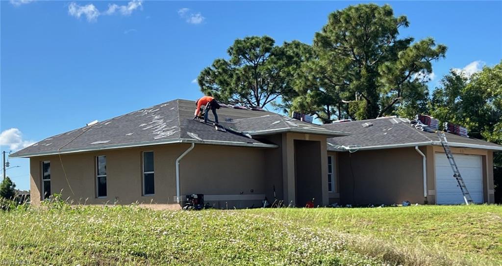 3513 30th Street Southwest Lehigh Acres, FL 33976 - Photo 7 of 29 a front view of house with yard