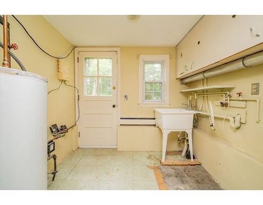 117 Woodland Road Springfield, MA 01129 - Photo 30 of 30 a living room with a couch and a stove next to a large window