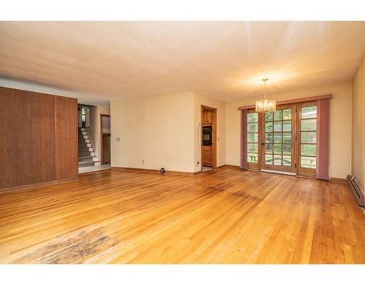 117 Woodland Road Springfield, MA 01129 - Photo 9 of 30 a view of an empty room with wooden floor and a window