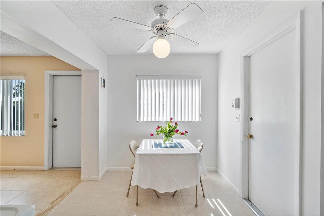 6419 Hitchin Post Way Delray Beach, FL 33484 - Photo 15 of 33 a view of a dining room with furniture window and wooden floor