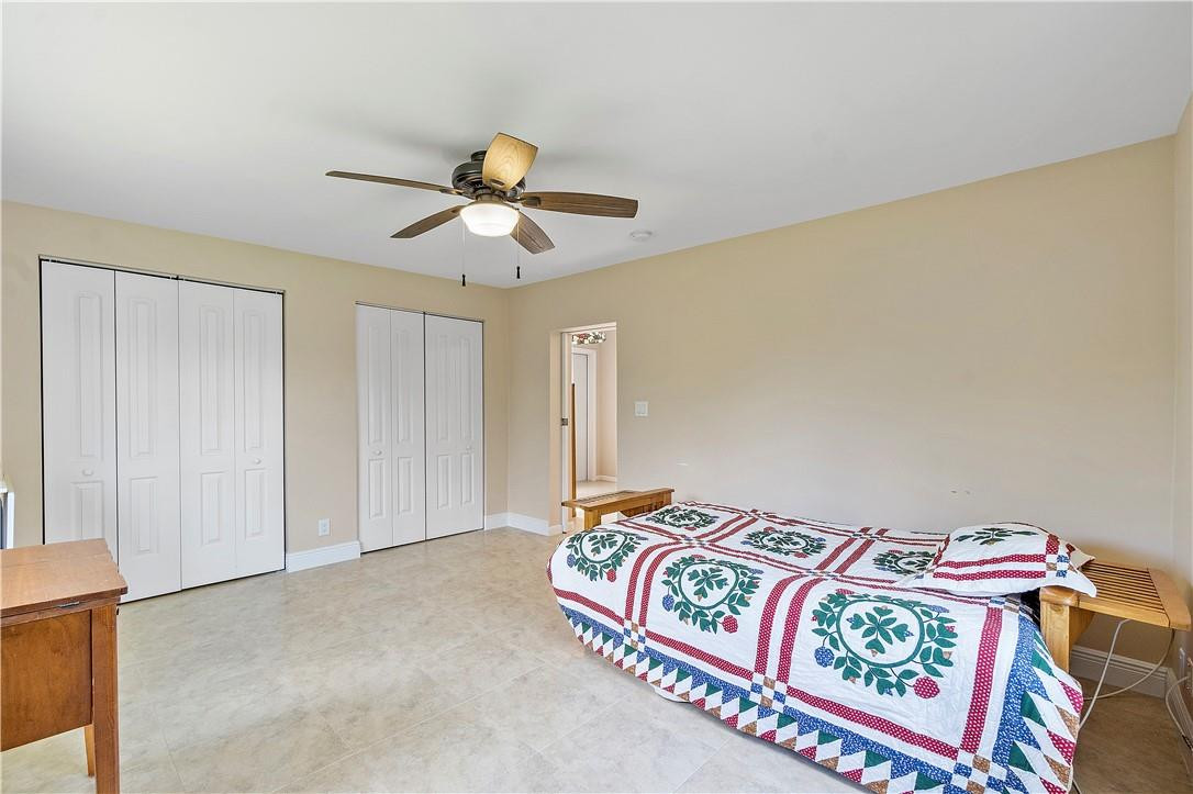 6419 Hitchin Post Way Delray Beach, FL 33484 - Photo 16 of 33 a bedroom with a bed and a chandelier