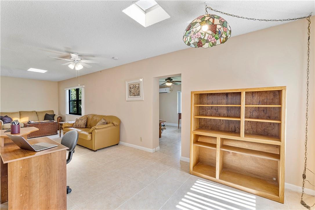 6419 Hitchin Post Way Delray Beach, FL 33484 - Photo 17 of 33 a living room with furniture and a floor to ceiling window