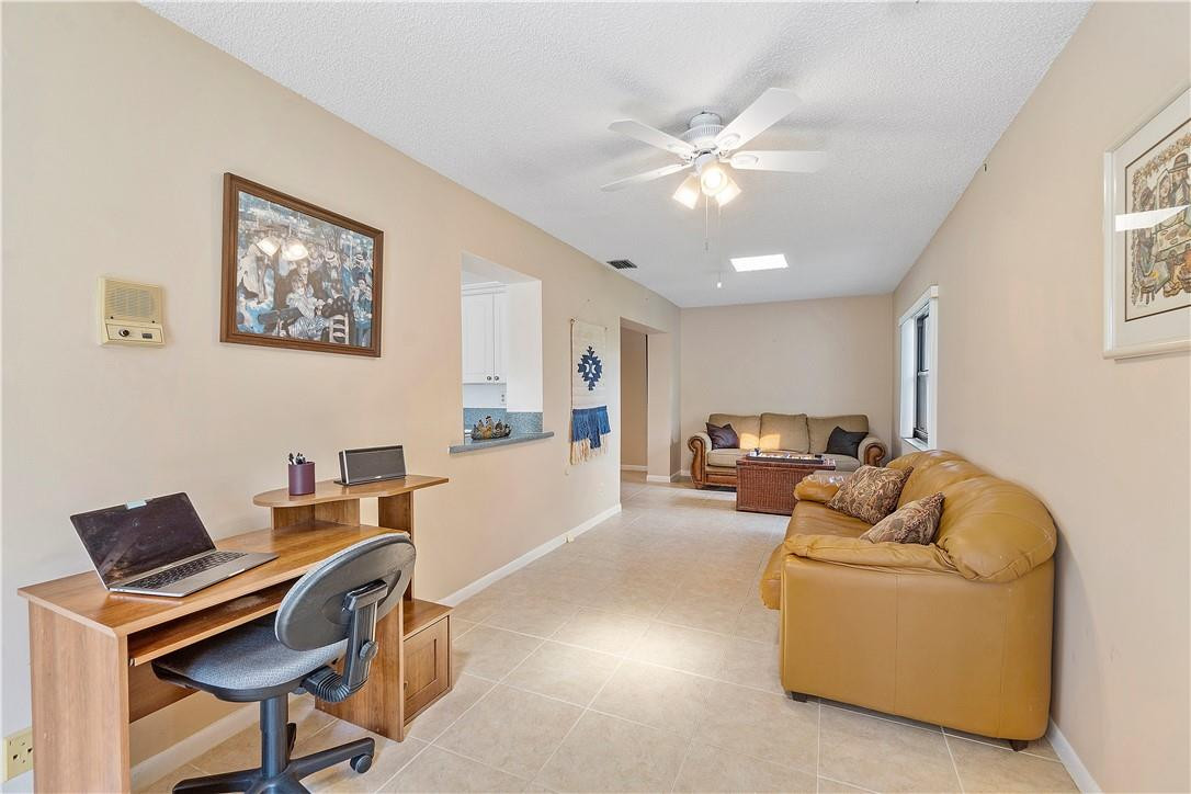 6419 Hitchin Post Way Delray Beach, FL 33484 - Photo 18 of 33 a living room with furniture and a chandelier