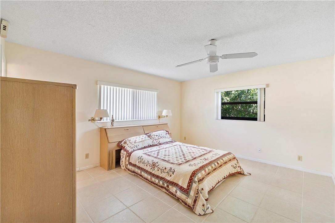 6419 Hitchin Post Way Delray Beach, FL 33484 - Photo 22 of 33 a bedroom with a bed and a window