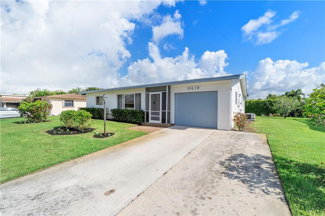 6419 Hitchin Post Way Delray Beach, FL 33484 - Photo 27 of 33 a front view of house with yard and green space