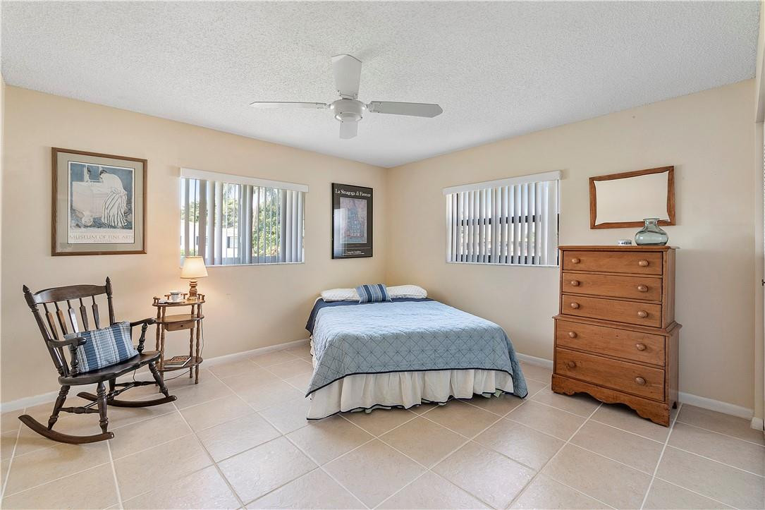 6419 Hitchin Post Way Delray Beach, FL 33484 - Photo 5 of 33 a bedroom with a bed and chair