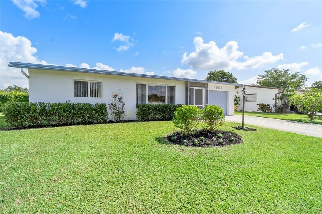 6419 Hitchin Post Way Delray Beach, FL 33484 - Photo 7 of 33 a front view of house with yard and green space