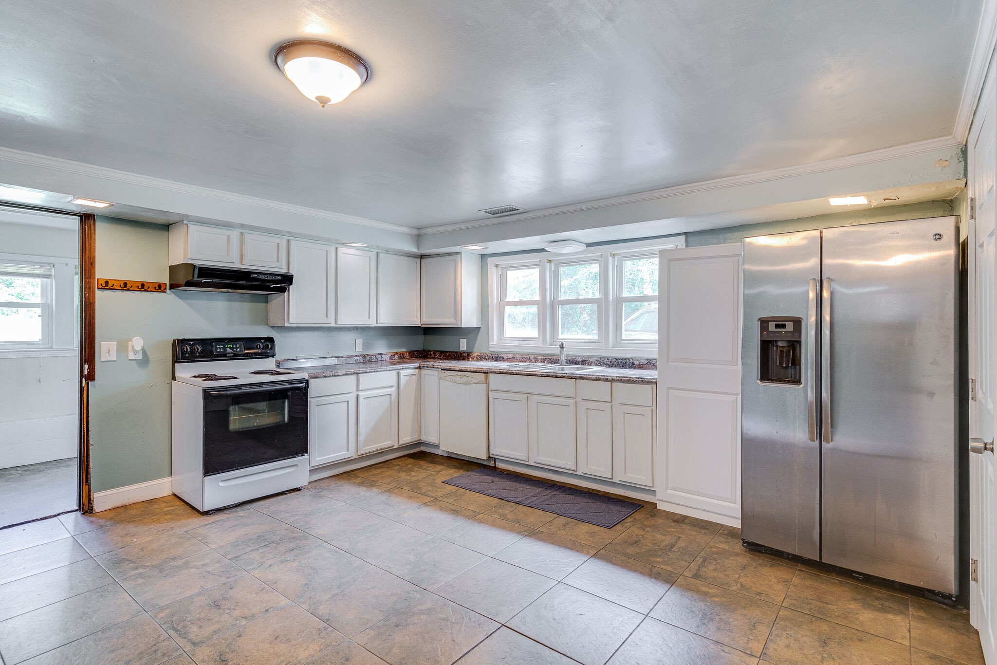 675 Holloway Road Lebanon, TN 37090 - Photo 13 of 32 a kitchen with granite countertop a refrigerator and a stove top oven