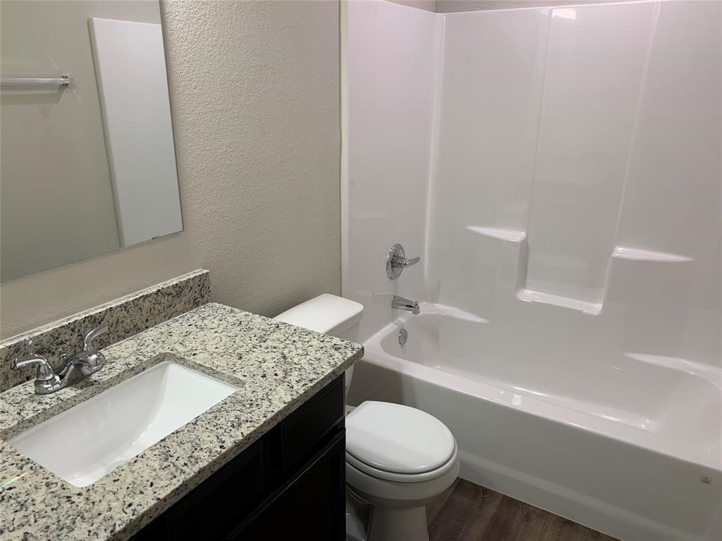 994 Arbor Crossing Conroe, TX 77303 - Photo 6 of 9 a bathroom with a granite countertop sink toilet and shower