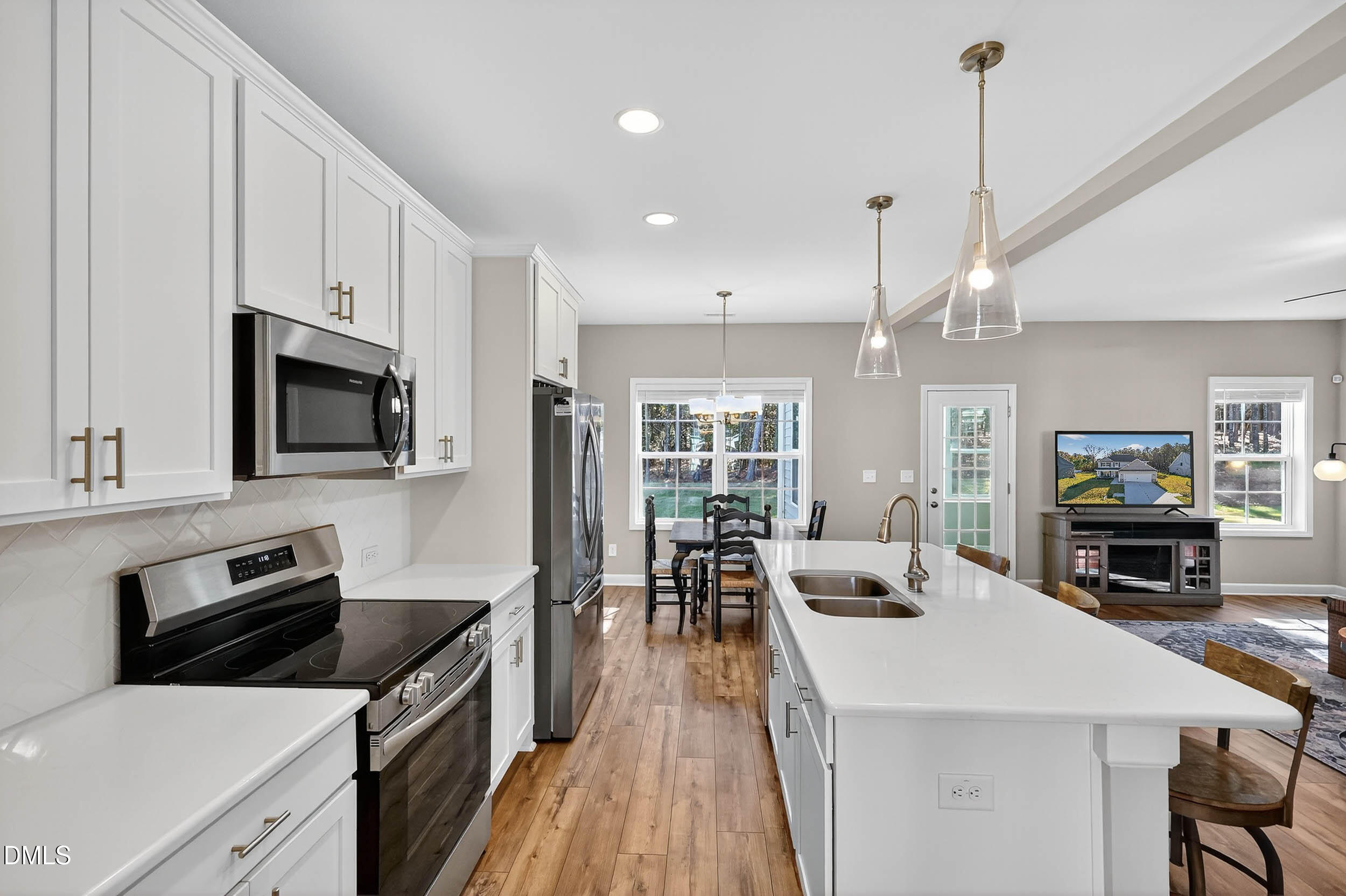 520 Husketh Road Youngsville, NC 27596 - Photo 11 of 63 a kitchen with stainless steel appliances a stove center island a stove cabinets a sink a oven a dining table and chairs