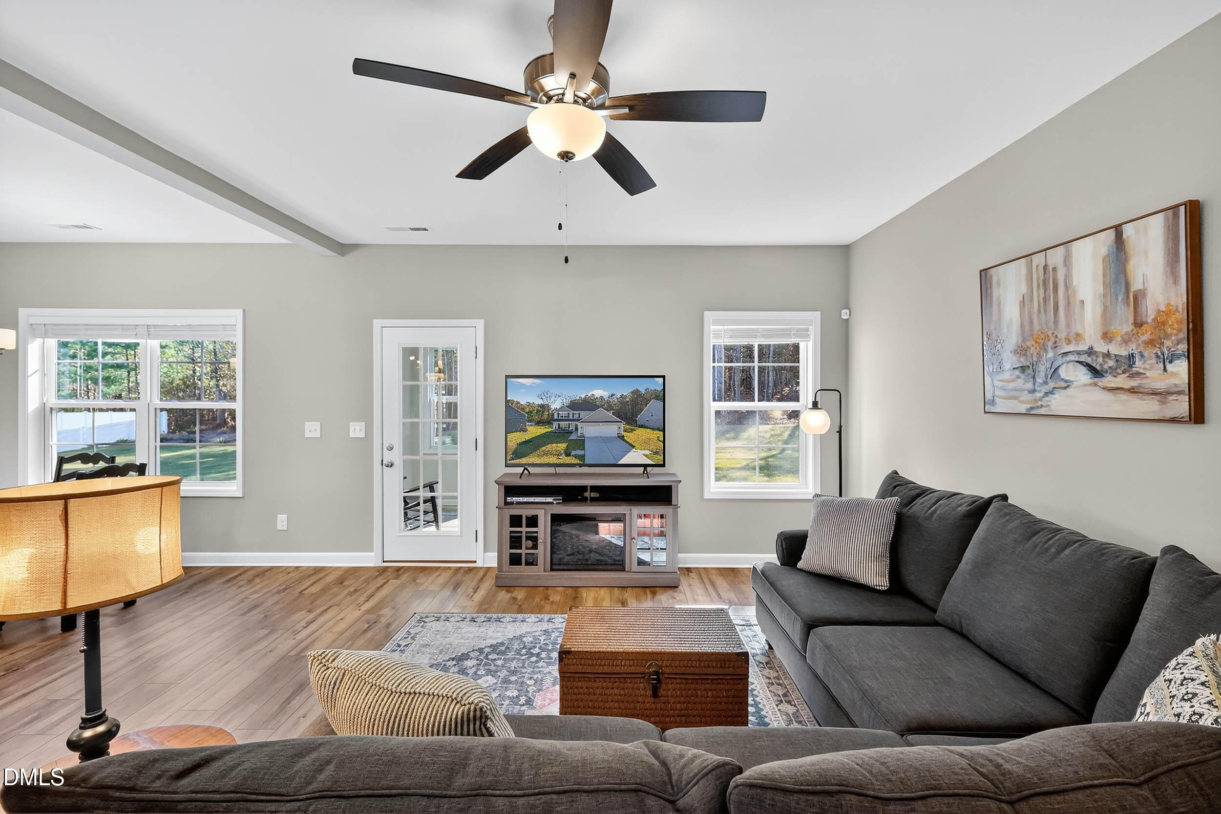 520 Husketh Road Youngsville, NC 27596 - Photo 20 of 63 a living room with furniture and a flat screen tv with wooden floor