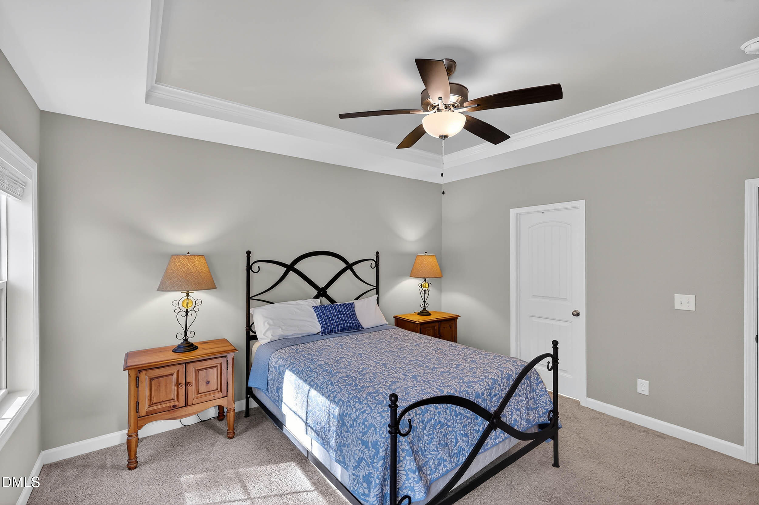 520 Husketh Road Youngsville, NC 27596 - Photo 22 of 63 a bedroom with a bed and a chandelier