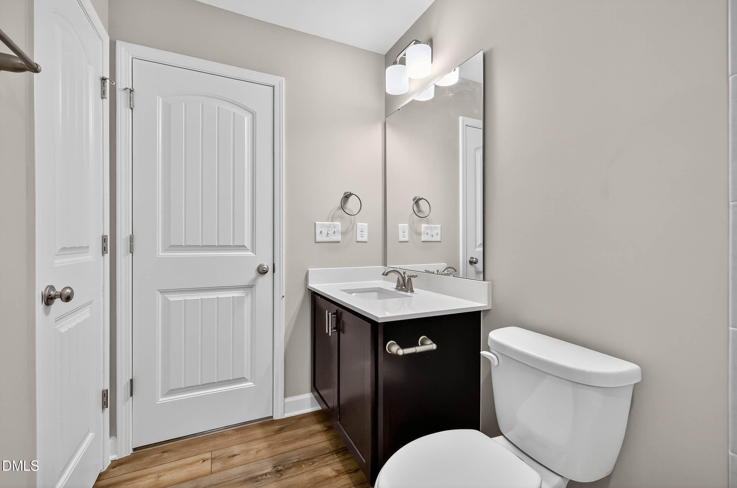 520 Husketh Road Youngsville, NC 27596 - Photo 44 of 63 a bathroom with a sink a toilet a mirror and vanity