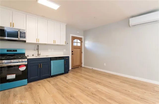 a kitchen with stainless steel appliances granite countertop a refrigerator and a stove top oven