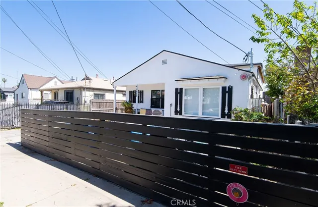 a front view of a house with a tree