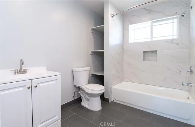a bathroom with a toilet sink and bathtub