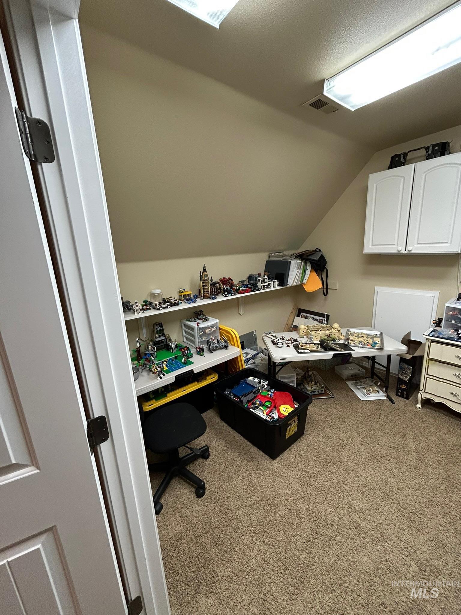 3091 Echo Road Nyssa, OR 97913 - Photo 14 of 36 Home office with vaulted ceiling, light carpet, and a textured ceiling