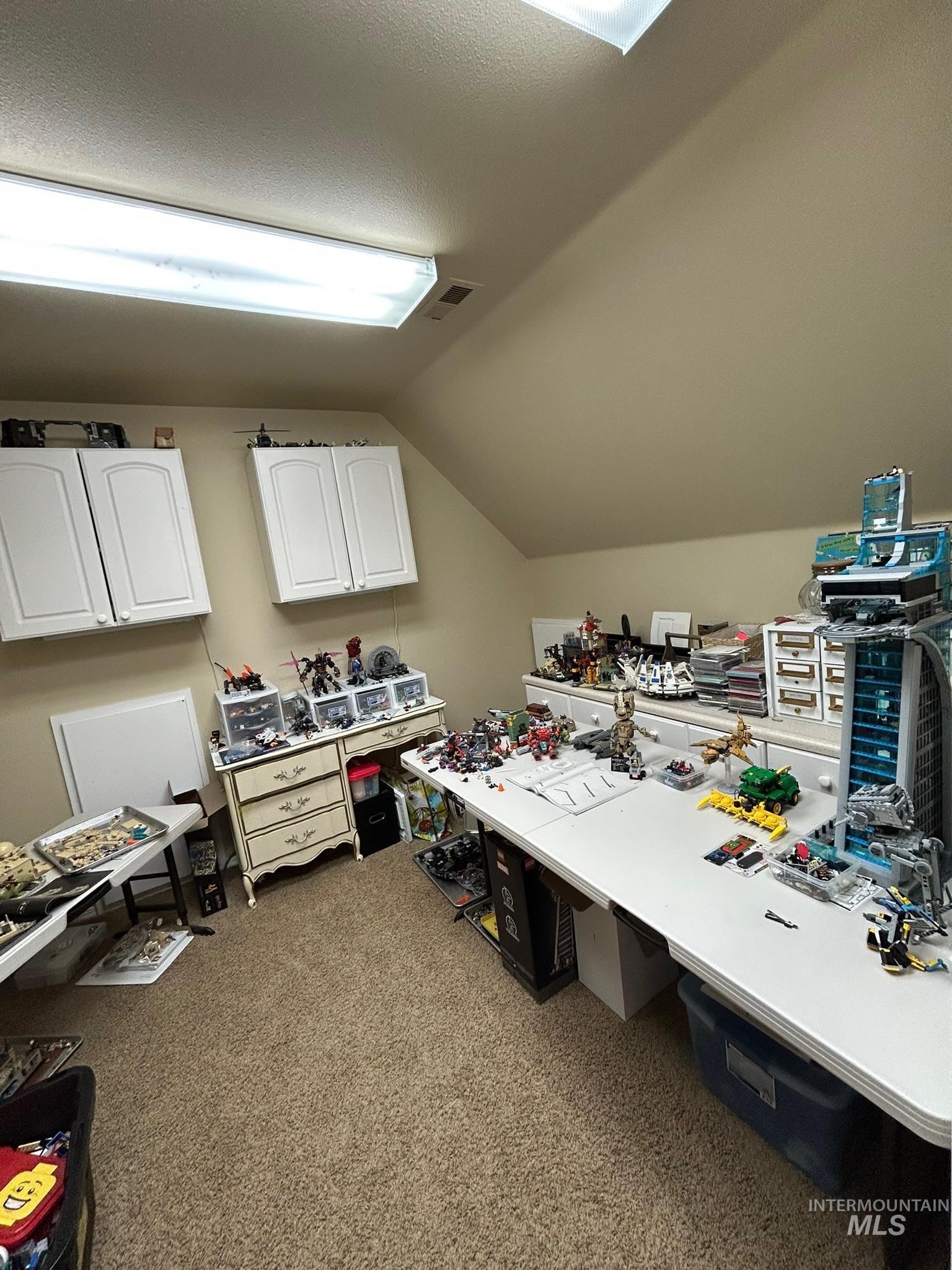 3091 Echo Road Nyssa, OR 97913 - Photo 16 of 36 Office area featuring lofted ceiling, light carpet, and a textured ceiling