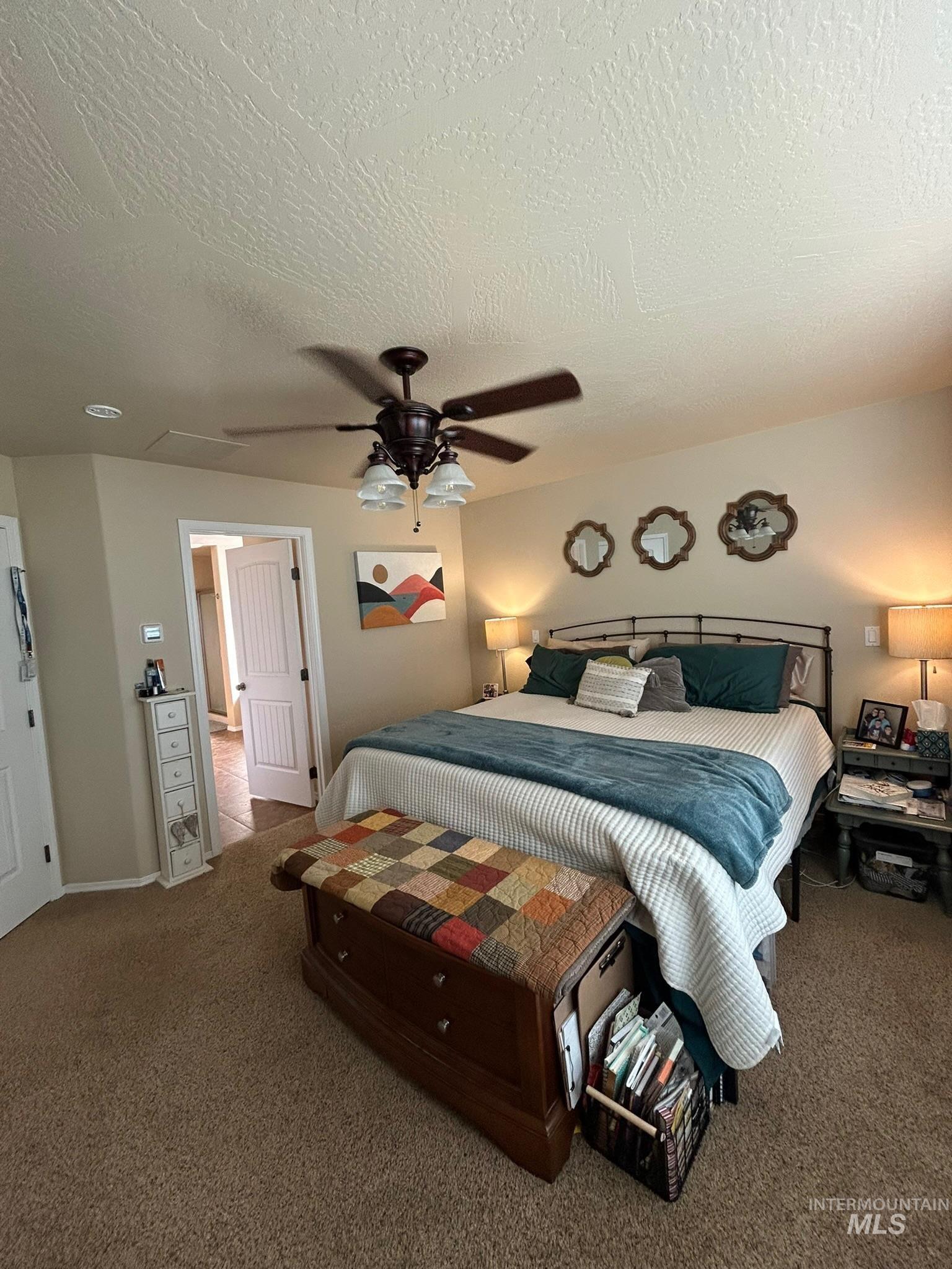 3091 Echo Road Nyssa, OR 97913 - Photo 17 of 36 Bedroom featuring carpet flooring, a textured ceiling, and ceiling fan