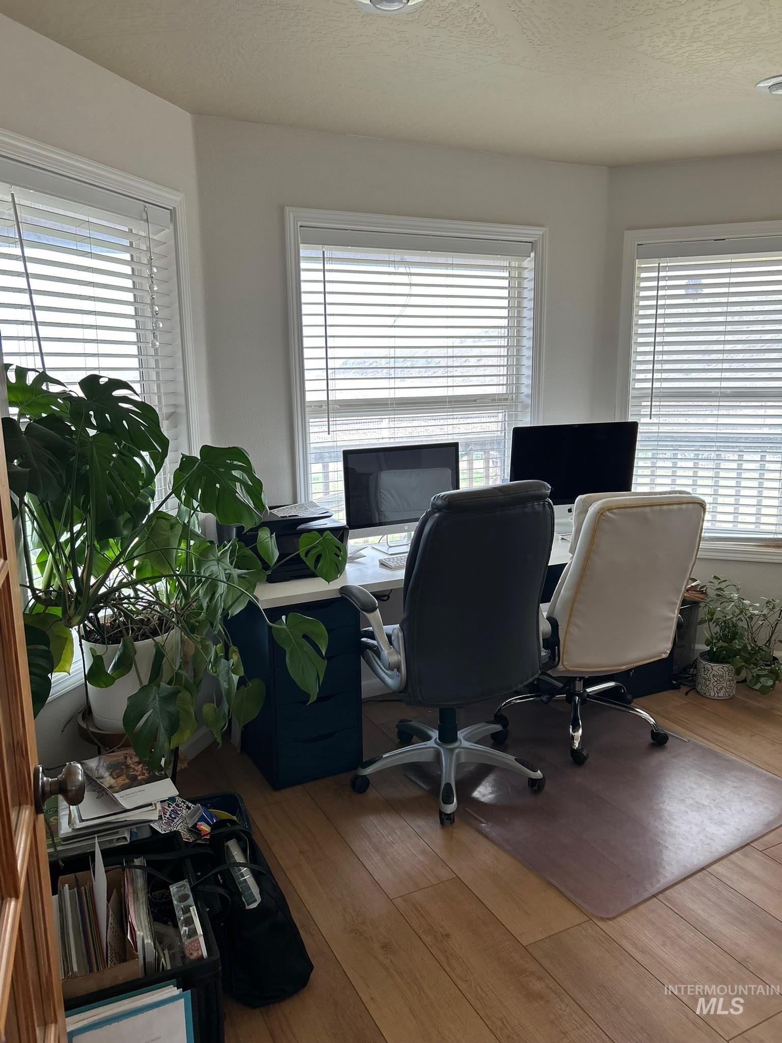 3091 Echo Road Nyssa, OR 97913 - Photo 24 of 36 Office area featuring wood finished floors, plenty of natural light, and a textured ceiling