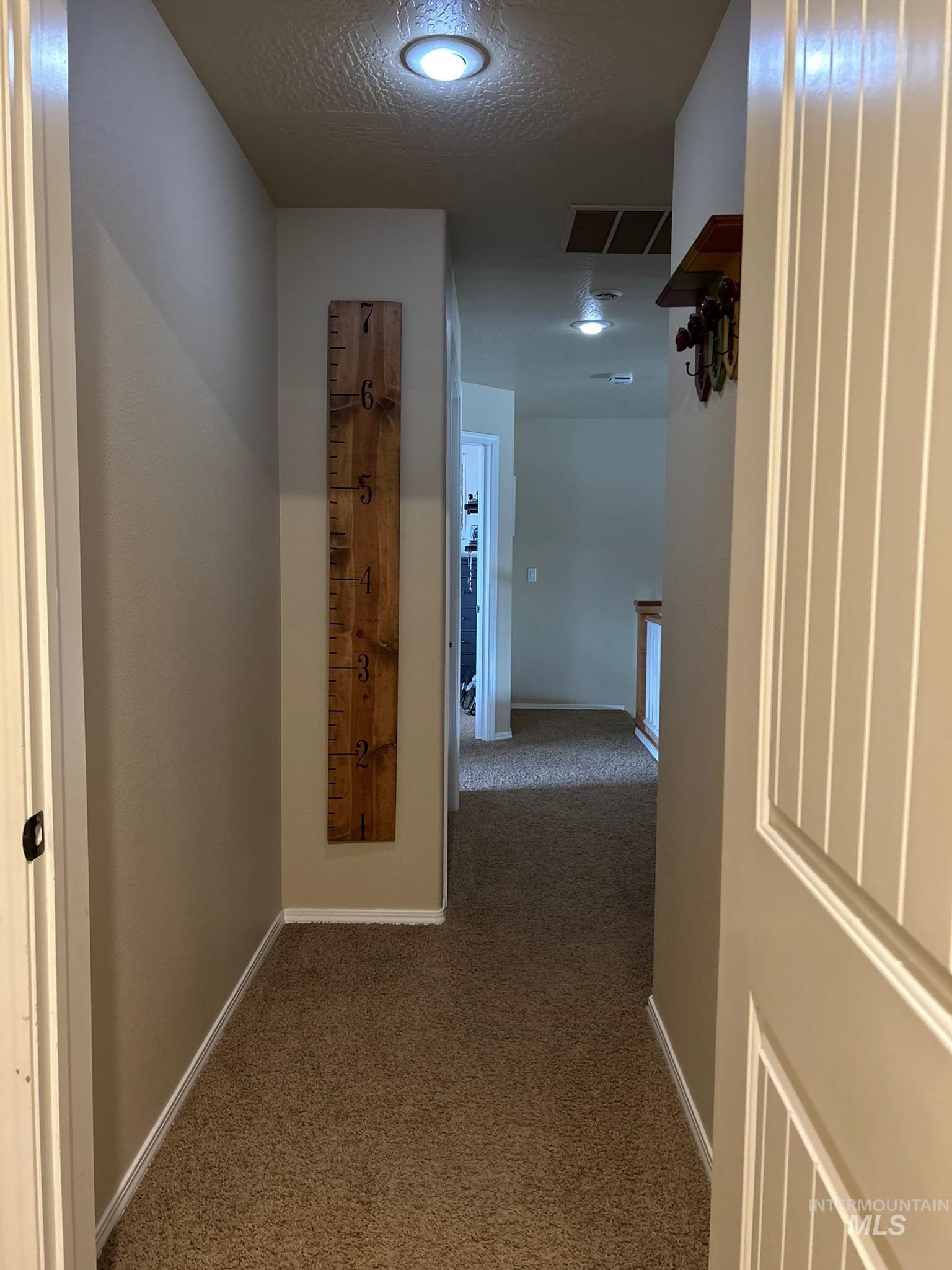 3091 Echo Road Nyssa, OR 97913 - Photo 31 of 36 Hallway with carpet floors and a textured ceiling