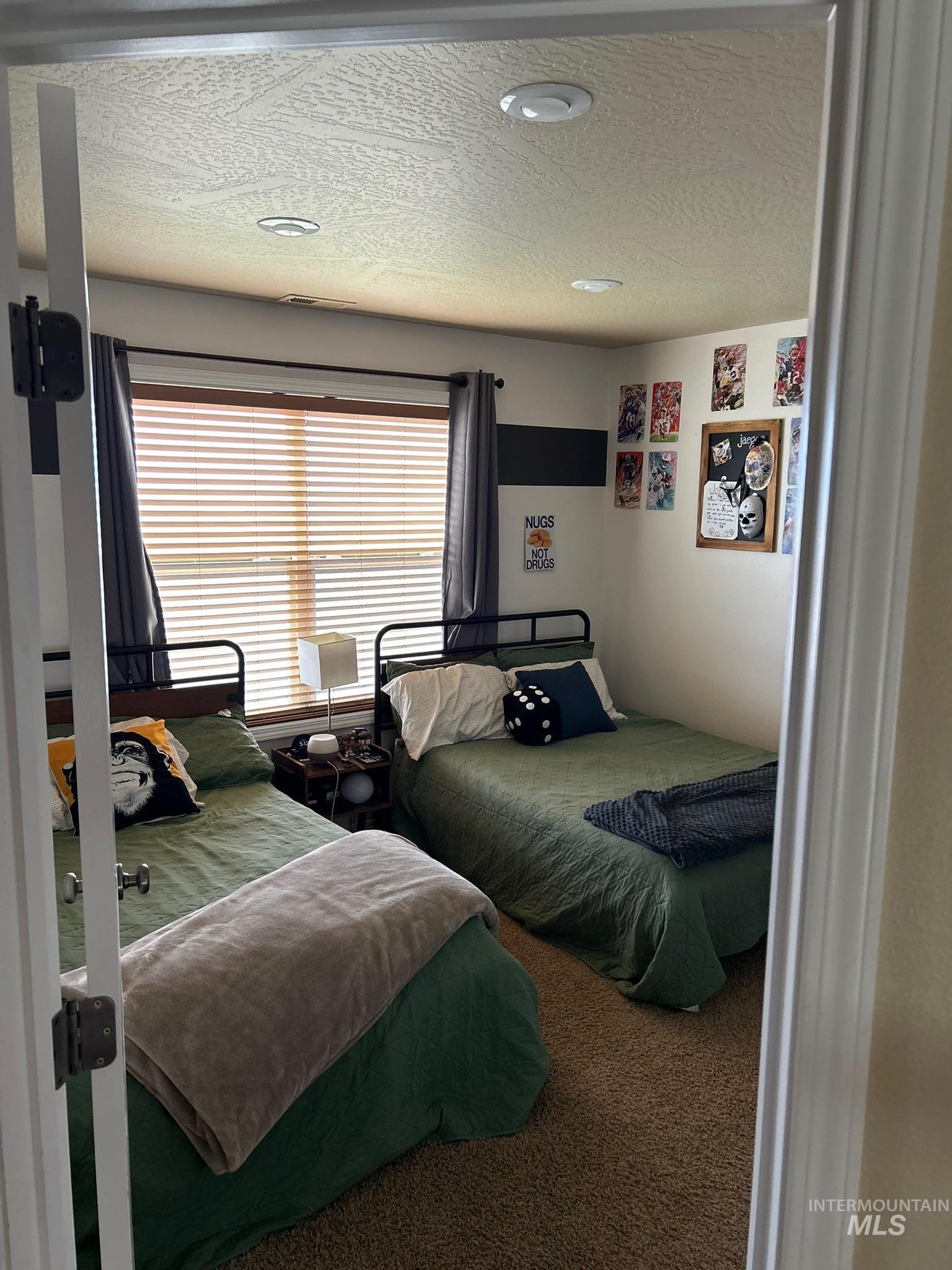 3091 Echo Road Nyssa, OR 97913 - Photo 32 of 36 Carpeted bedroom with a textured ceiling
