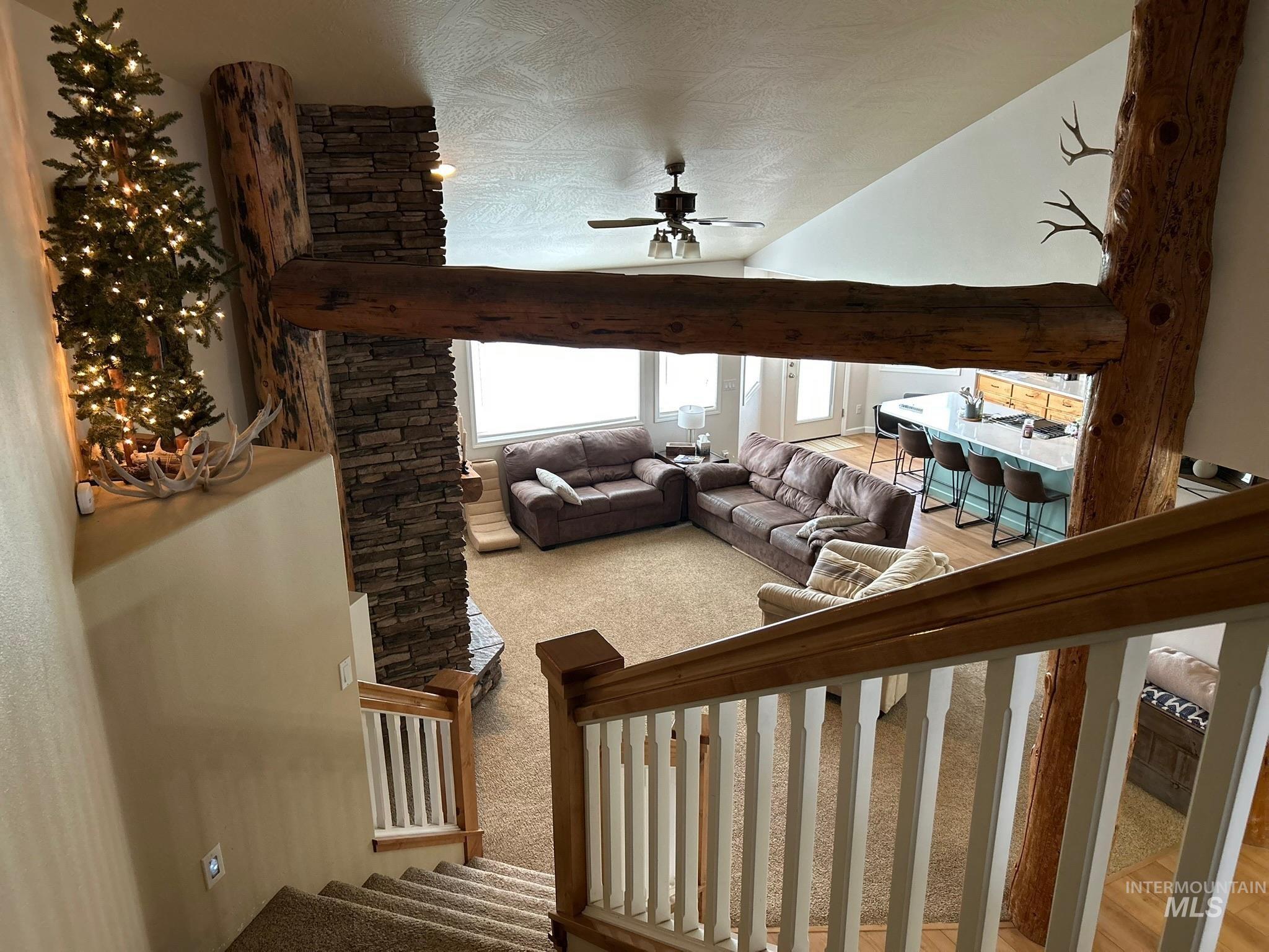 3091 Echo Road Nyssa, OR 97913 - Photo 5 of 36 Staircase featuring carpet flooring, vaulted ceiling, a ceiling fan, and a textured ceiling