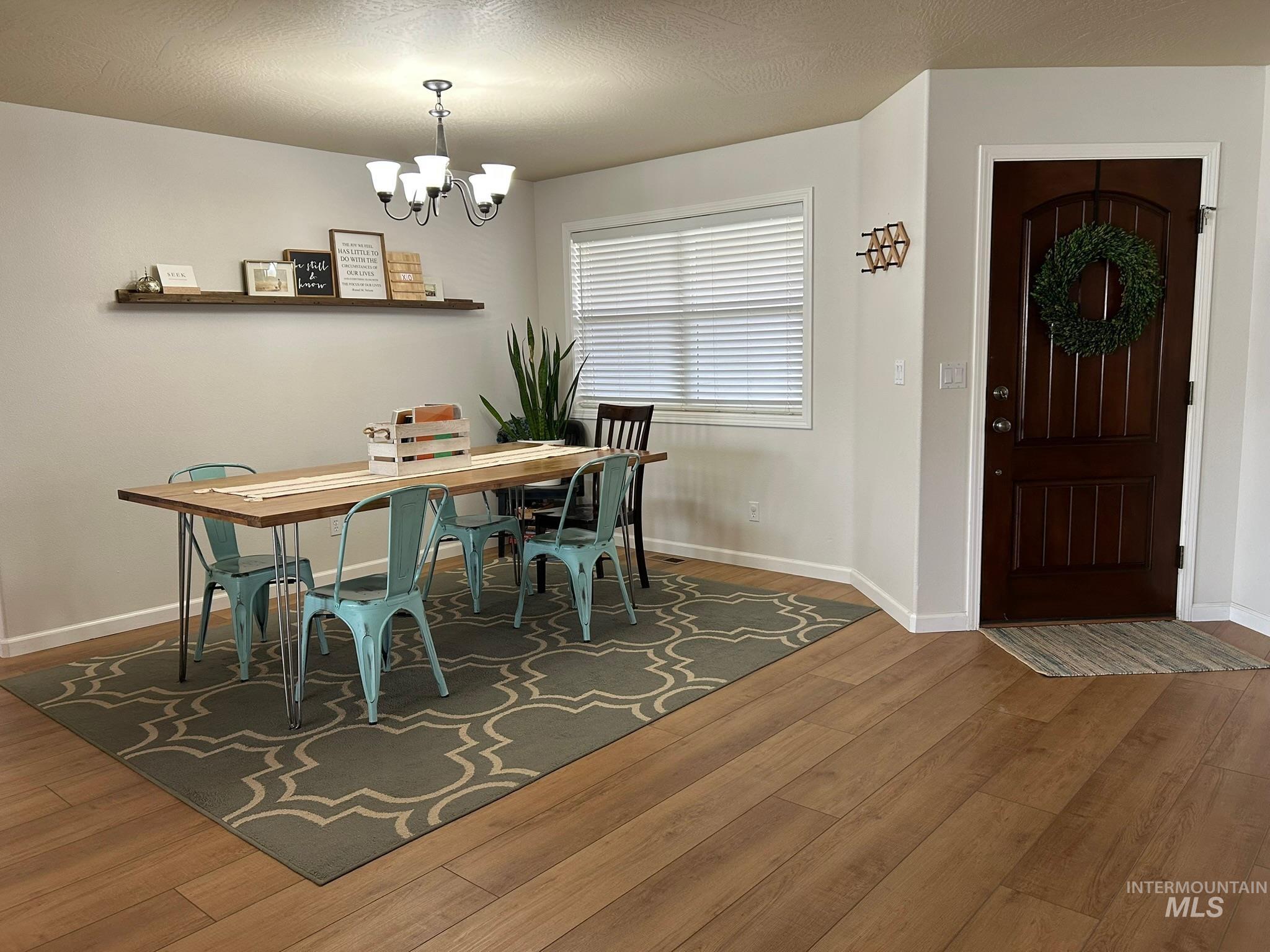 3091 Echo Road Nyssa, OR 97913 - Photo 6 of 36 Dining area with wood finished floors, a textured ceiling, and a chandelier