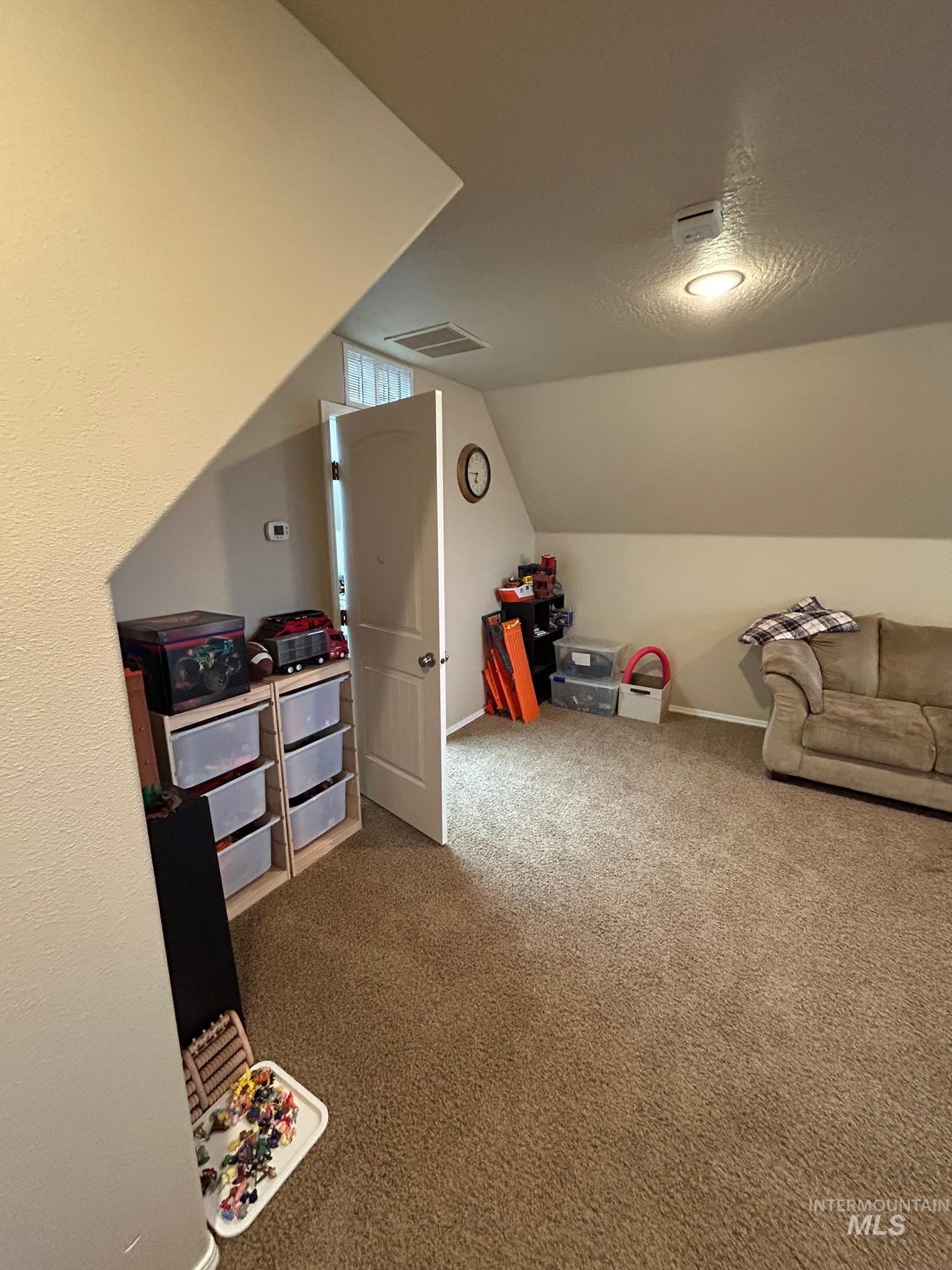 3091 Echo Road Nyssa, OR 97913 - Photo 8 of 36 Rec room featuring carpet floors, a textured ceiling, and lofted ceiling