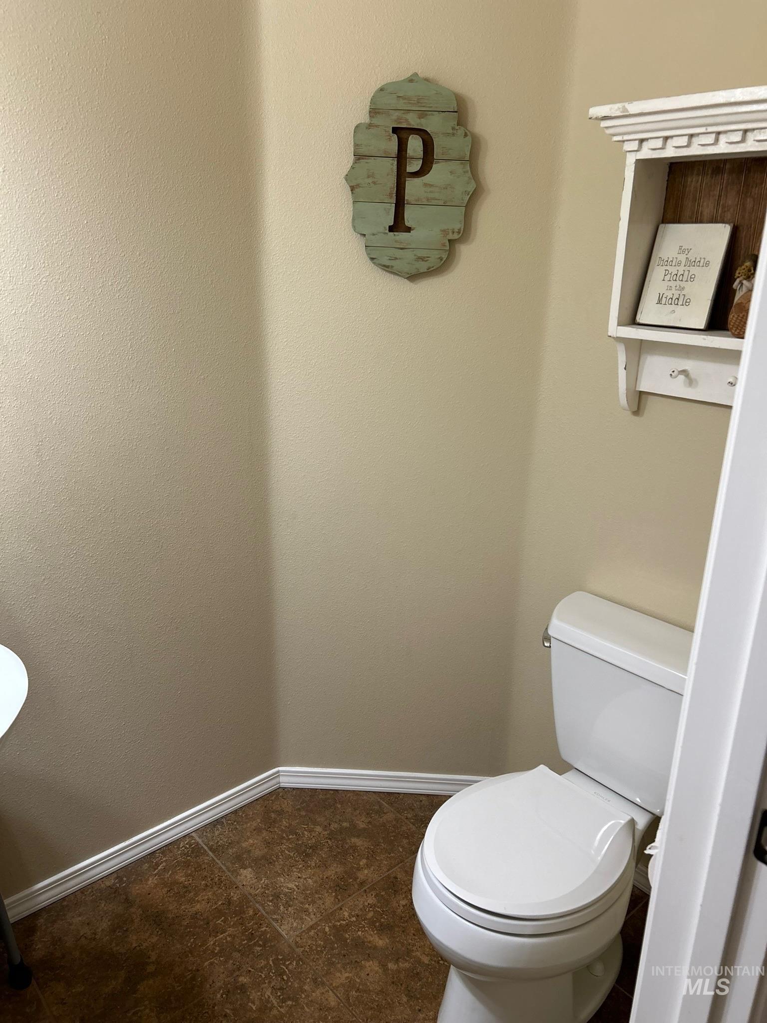 3091 Echo Road Nyssa, OR 97913 - Photo 9 of 36 Bathroom with baseboards and dark tile patterned flooring