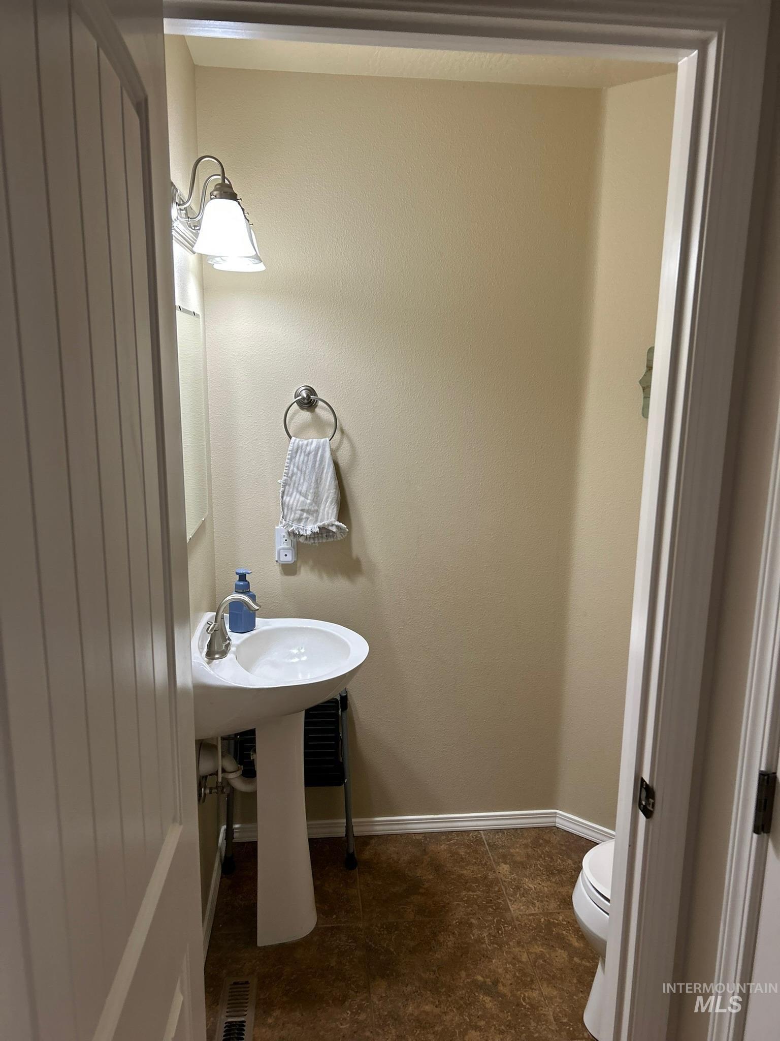 3091 Echo Road Nyssa, OR 97913 - Photo 10 of 36 Bathroom featuring toilet and dark tile patterned floors
