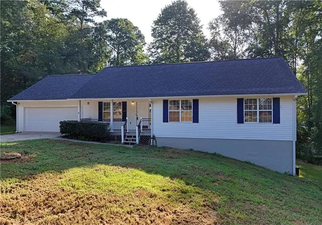 a front view of a house with a garden