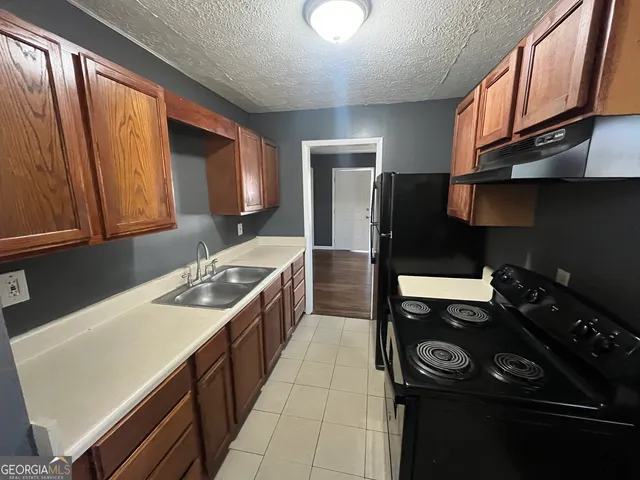 a kitchen with a stove and a refrigerator