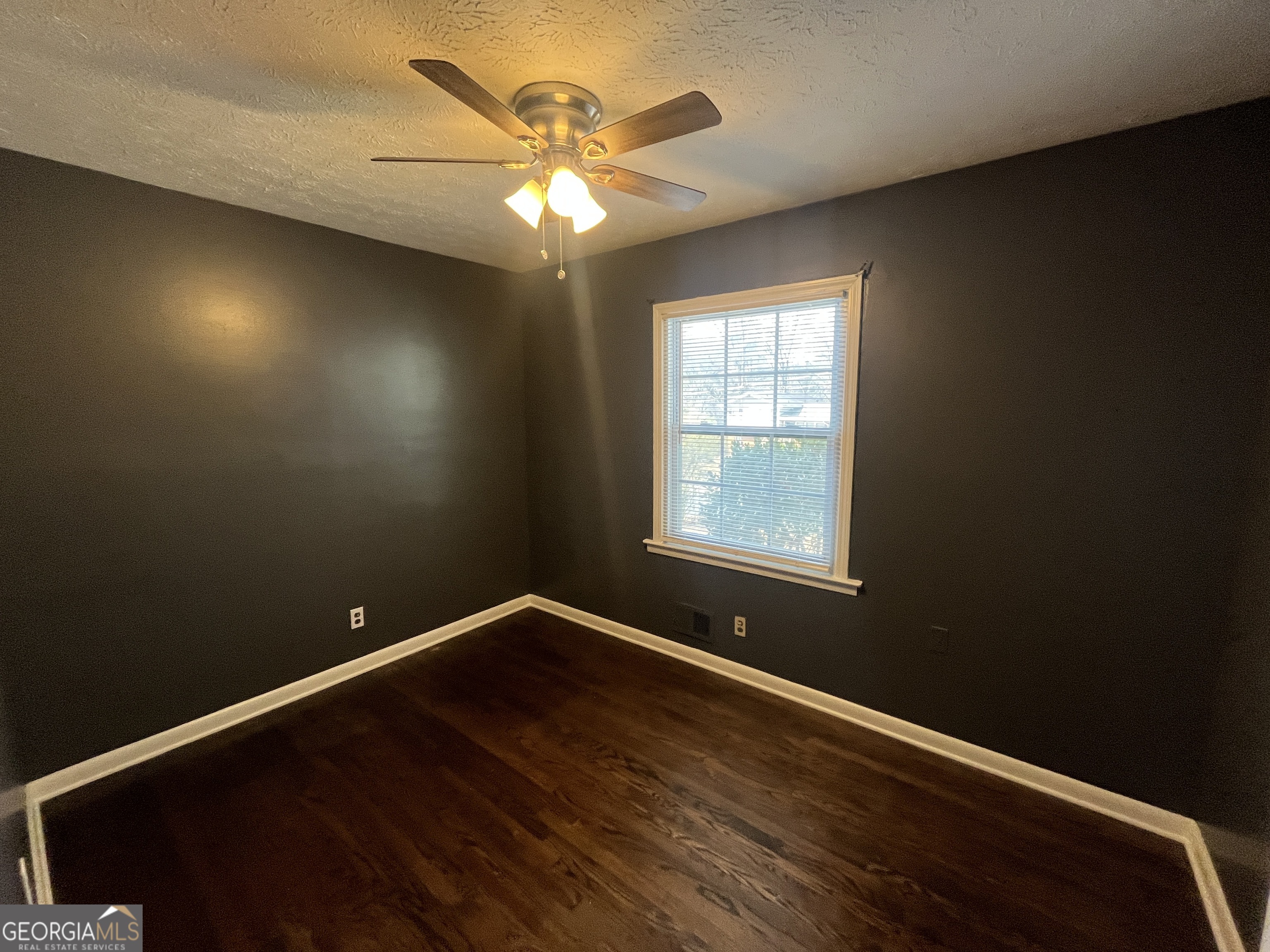 3490 Garfield Way Southeast Atlanta, GA 30354 - Photo 7 of 13 an empty room with wooden floor and windows